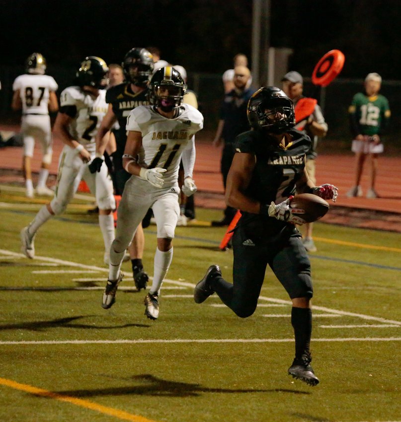 Arapahoe's Alonzo Ramirez breaks free from Rock Canyon's defense, including Nathanial Wilson(11) during the Warriors' homecoming game Sept. 23 in Littleton.